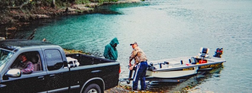 An older photograph of anglers loading a trout boat on the Little Red River